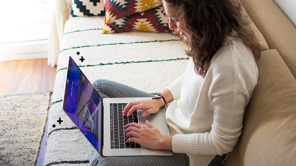 Woman using MacBook that won't connect to Wi-Fi