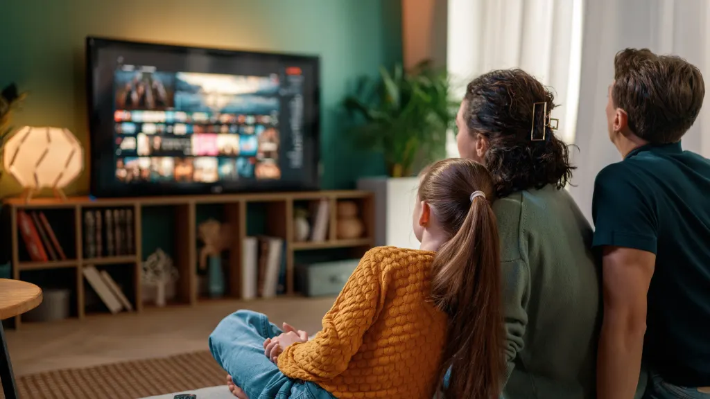Lifestyle image of a family watching a streaming service on a TV