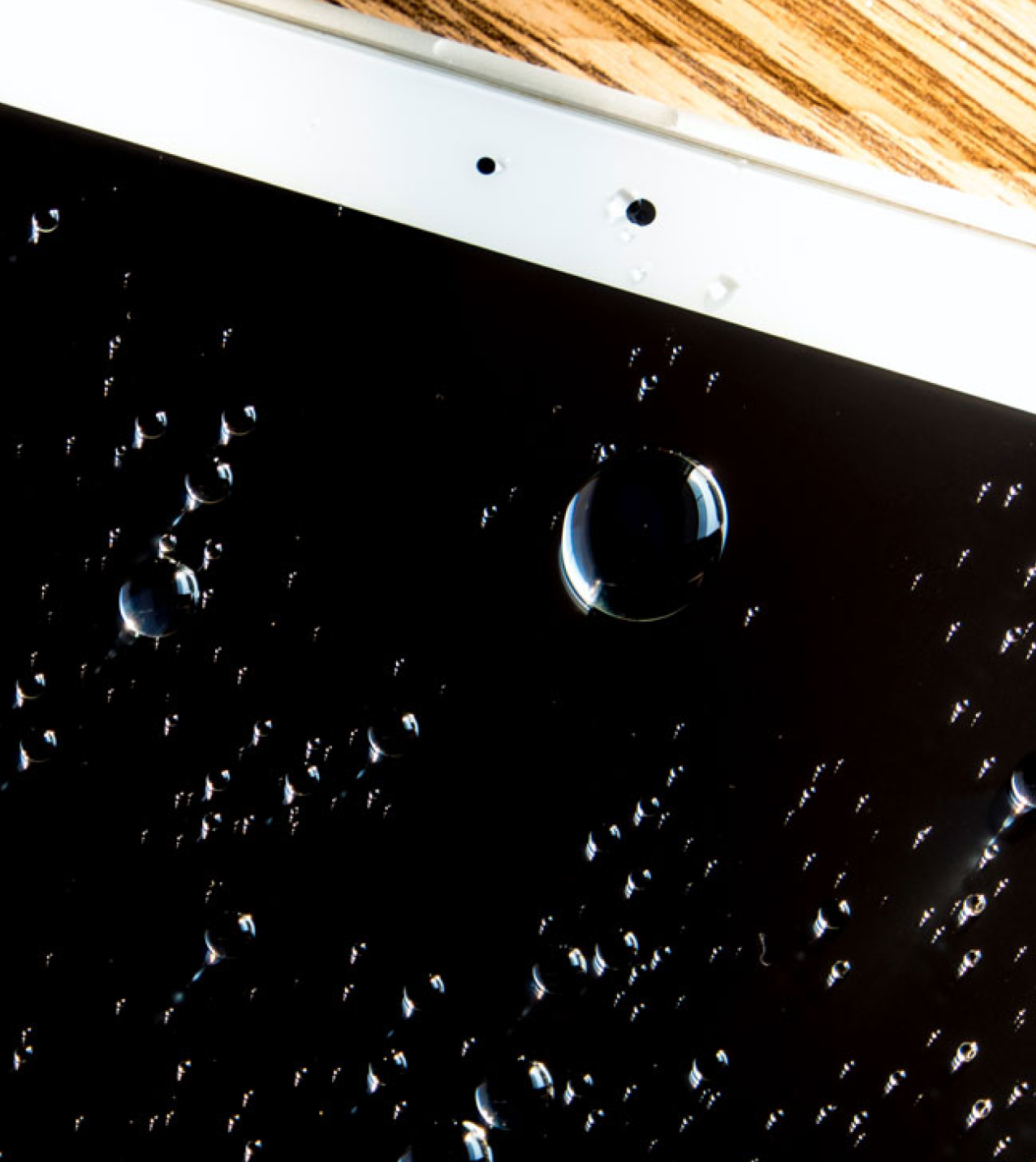 Beaded droplets of water on a tablet screen