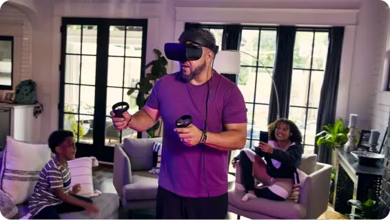 Dad uses a VR headset while the kids watch