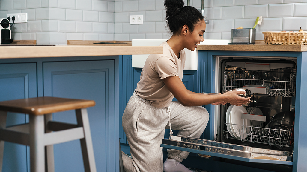 Woman loading dishwasher