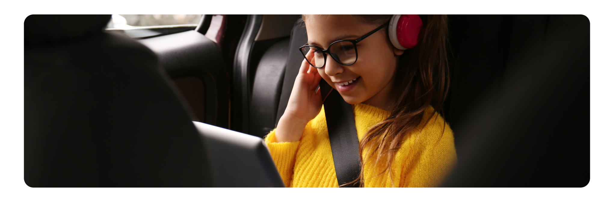 Kid in a car seat with a tablet