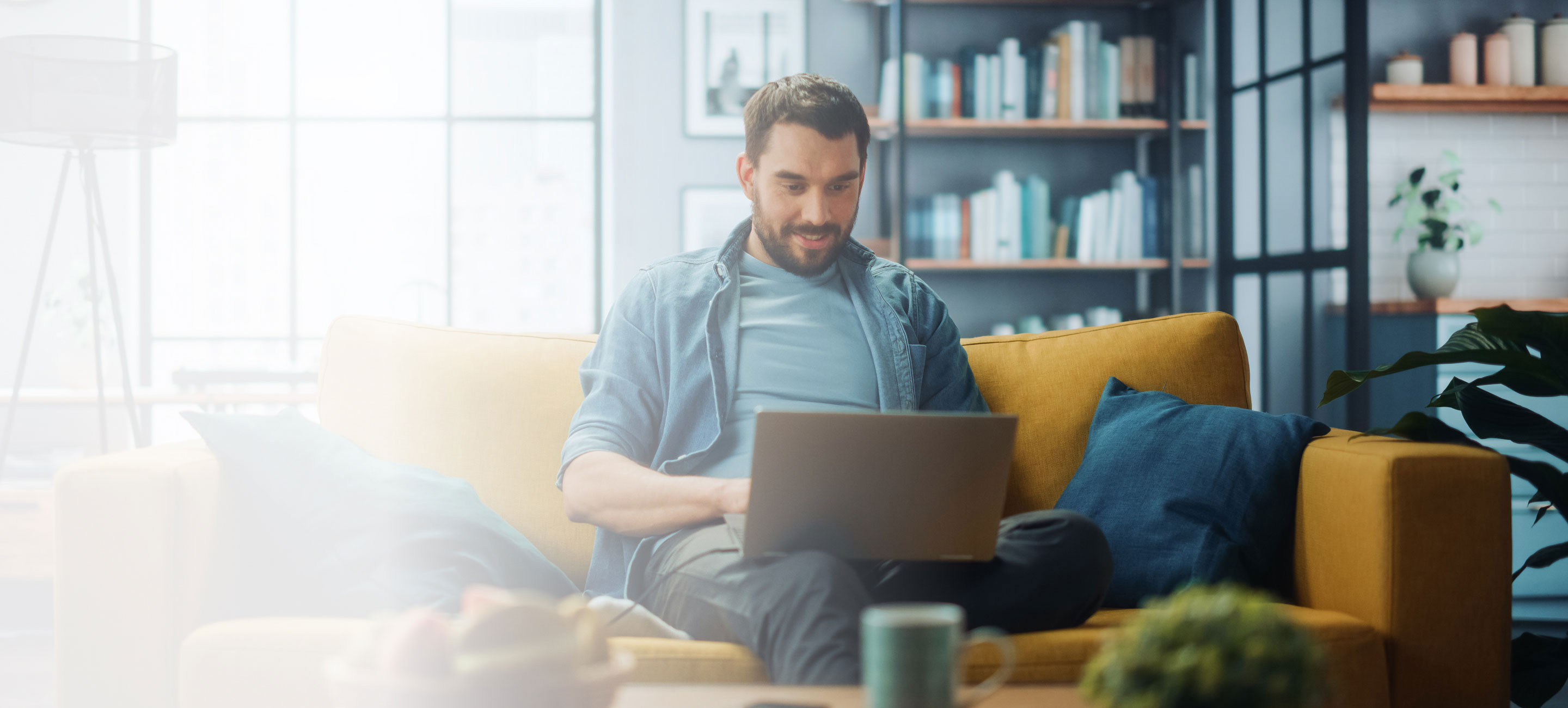 male using laptop in living room