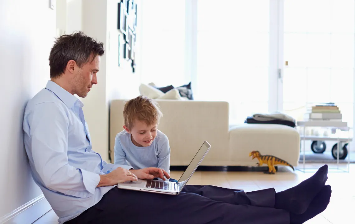 Father and son looking at a computer