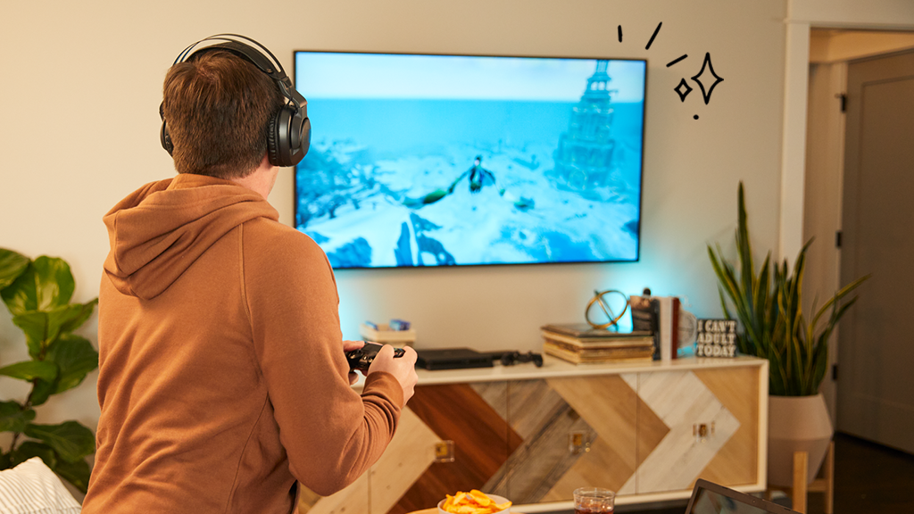 Man in living room playing games on his new smart TV