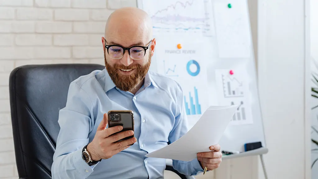 Man using iPhone shortcuts at work