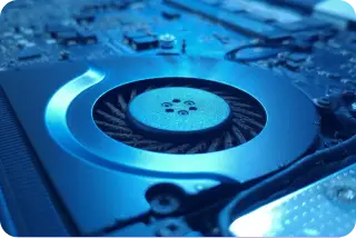 Dusty laptop cooling fan inside a computer showing buildup on internal components.