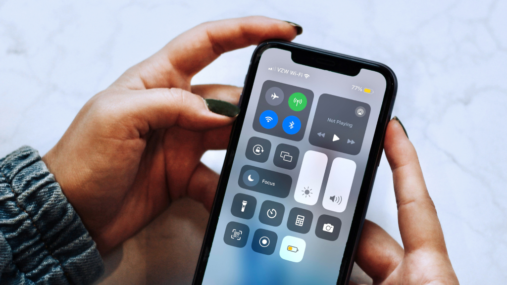 Person turning on low power mode from iPhone control center