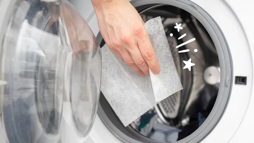 Person putting dryer sheet in dryer