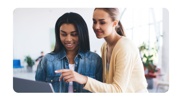 Two women using a laptop