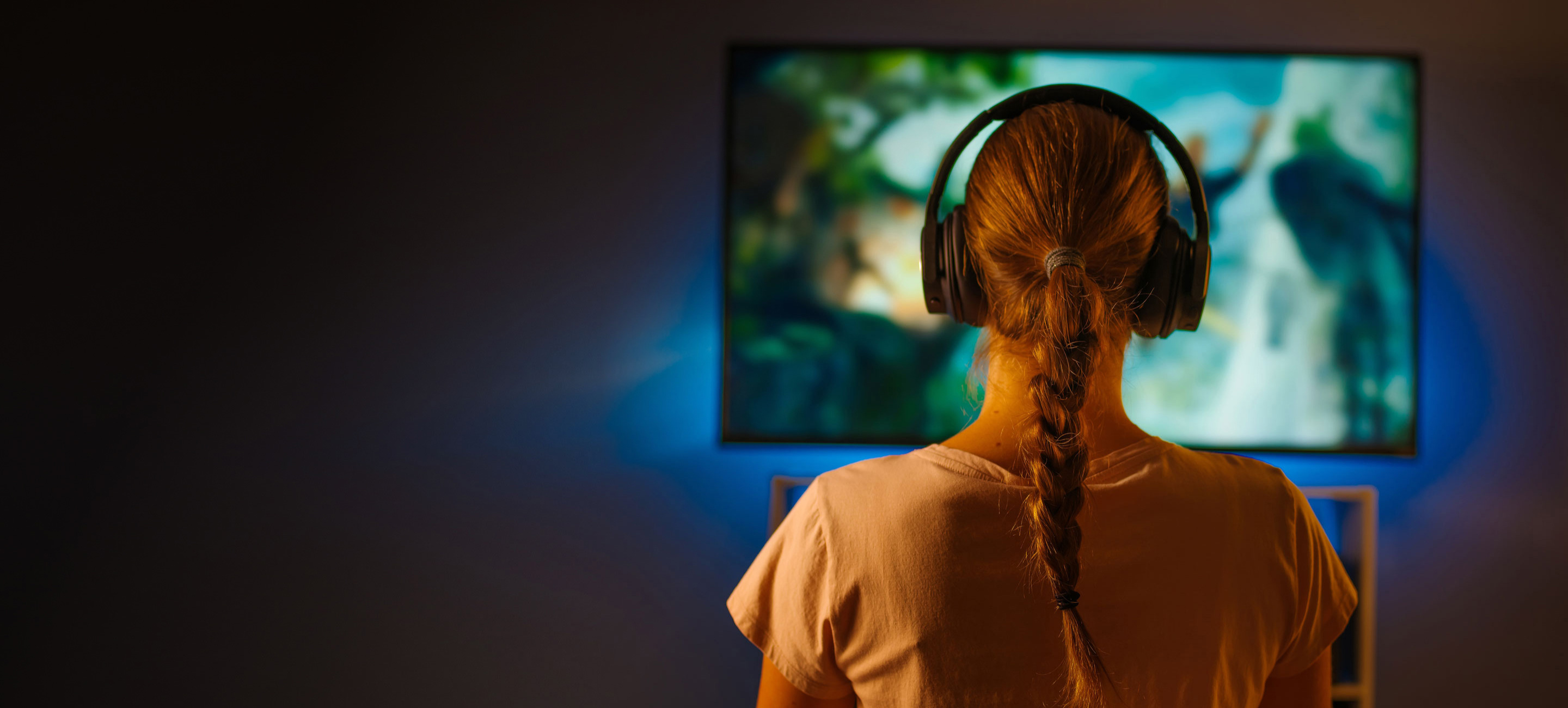 woman watching TV with headphones