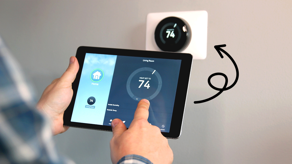 Person controlling smart thermostat from tablet