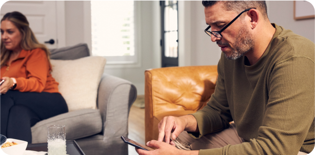 Man using phone on a couch