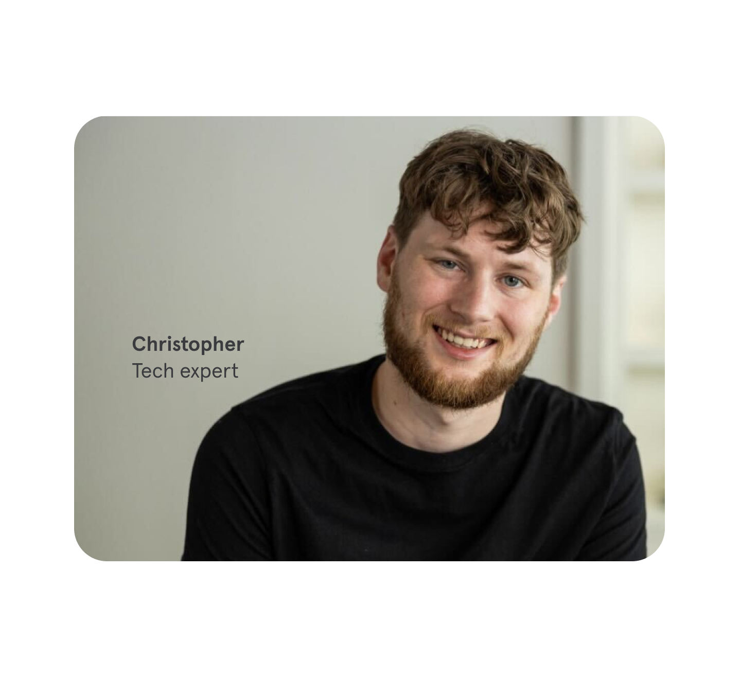 A friendly tech support expert named Christopher is smiling at the camera