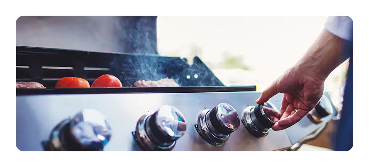 Hand turning on a grill