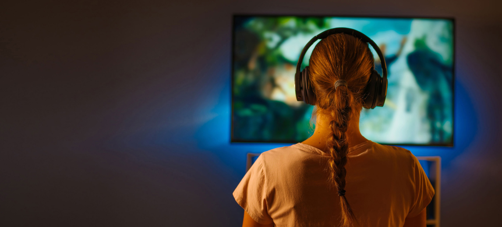 woman watching TV with headphones