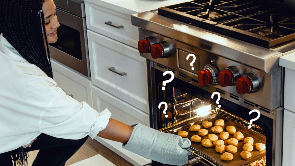 Woman pulling baked food out of oven