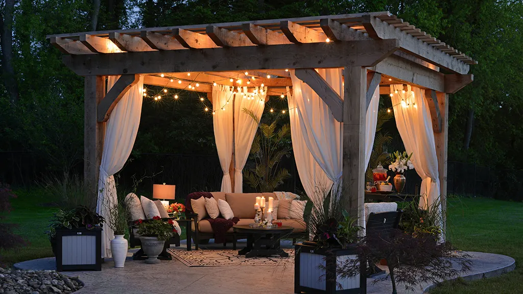 A smart outdoor patio space lit up at night with smart lights