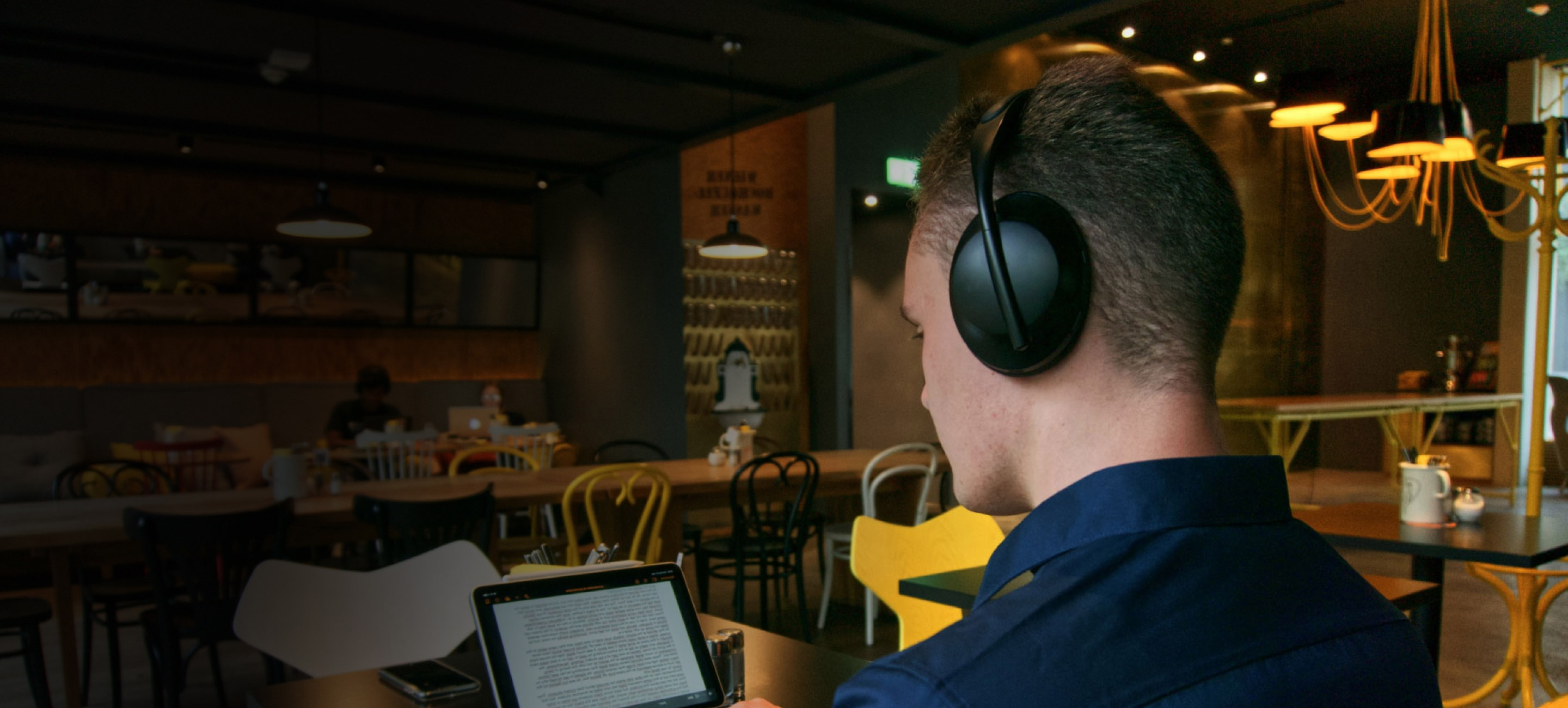 man wearing headphone in restaurant