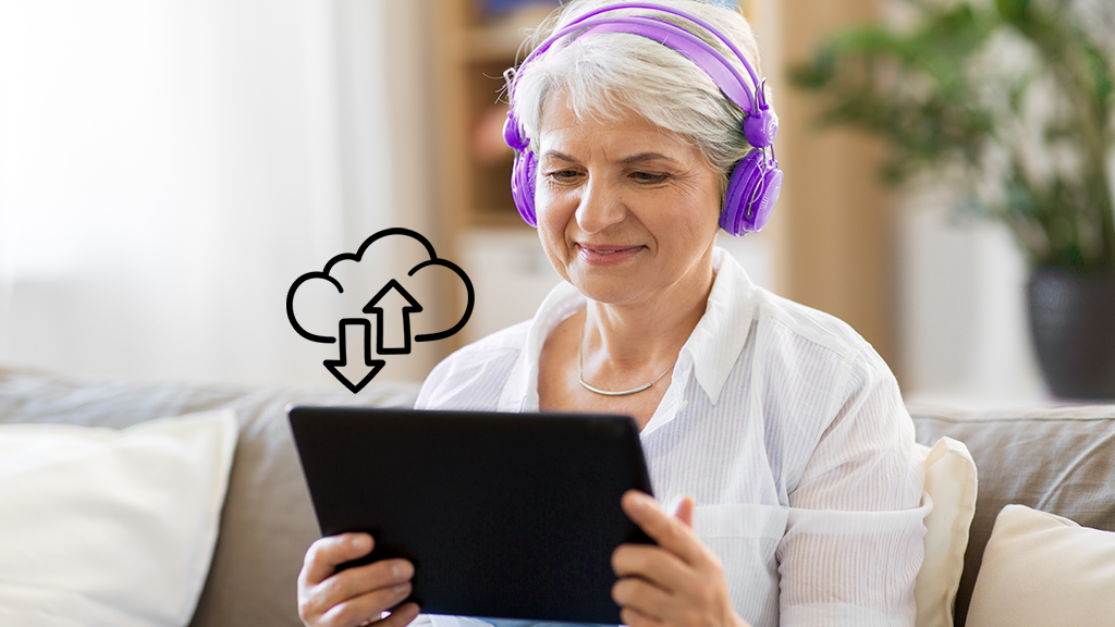 Person looking at laptop while uploading data to the cloud