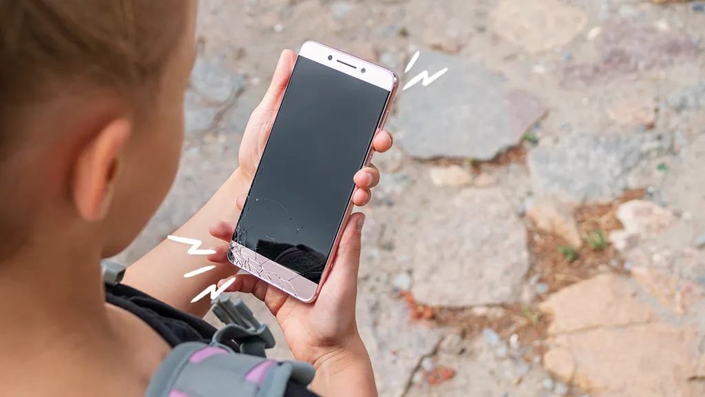 Girl looks at a cracked phone 