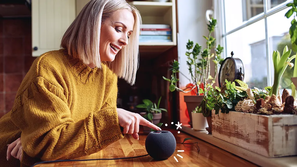 woman clicking the on switch of a smart home hub 