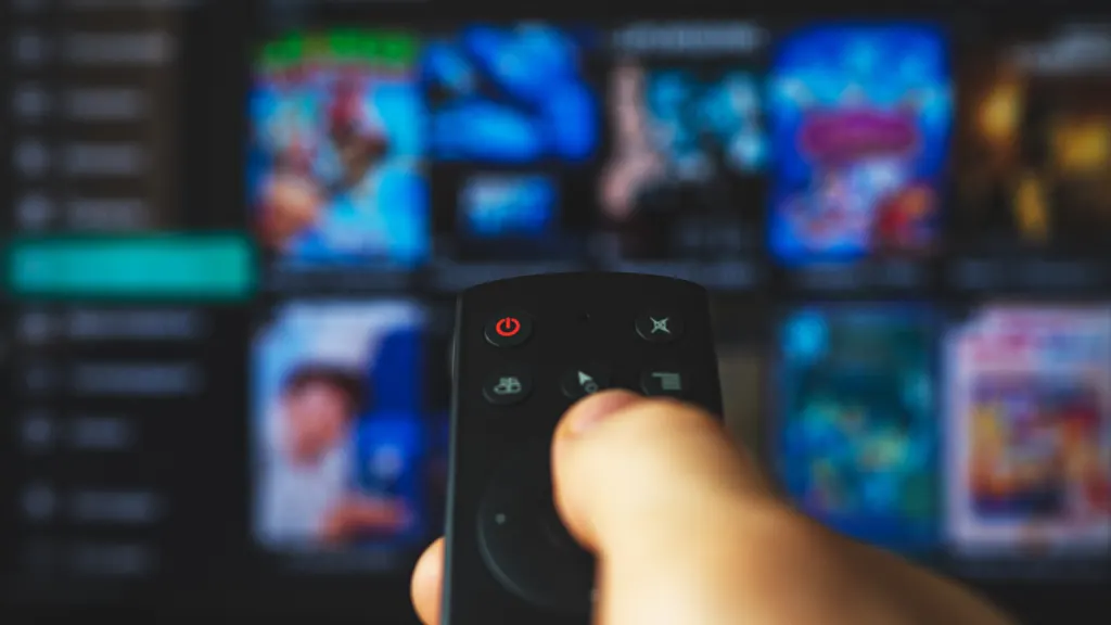 Closeup of Roku remote pointed at a TV