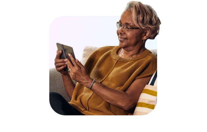 woman on couch holding tablet