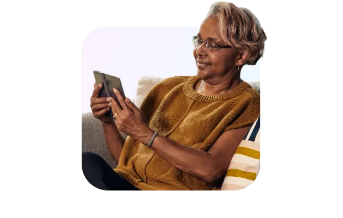 woman on couch holding tablet