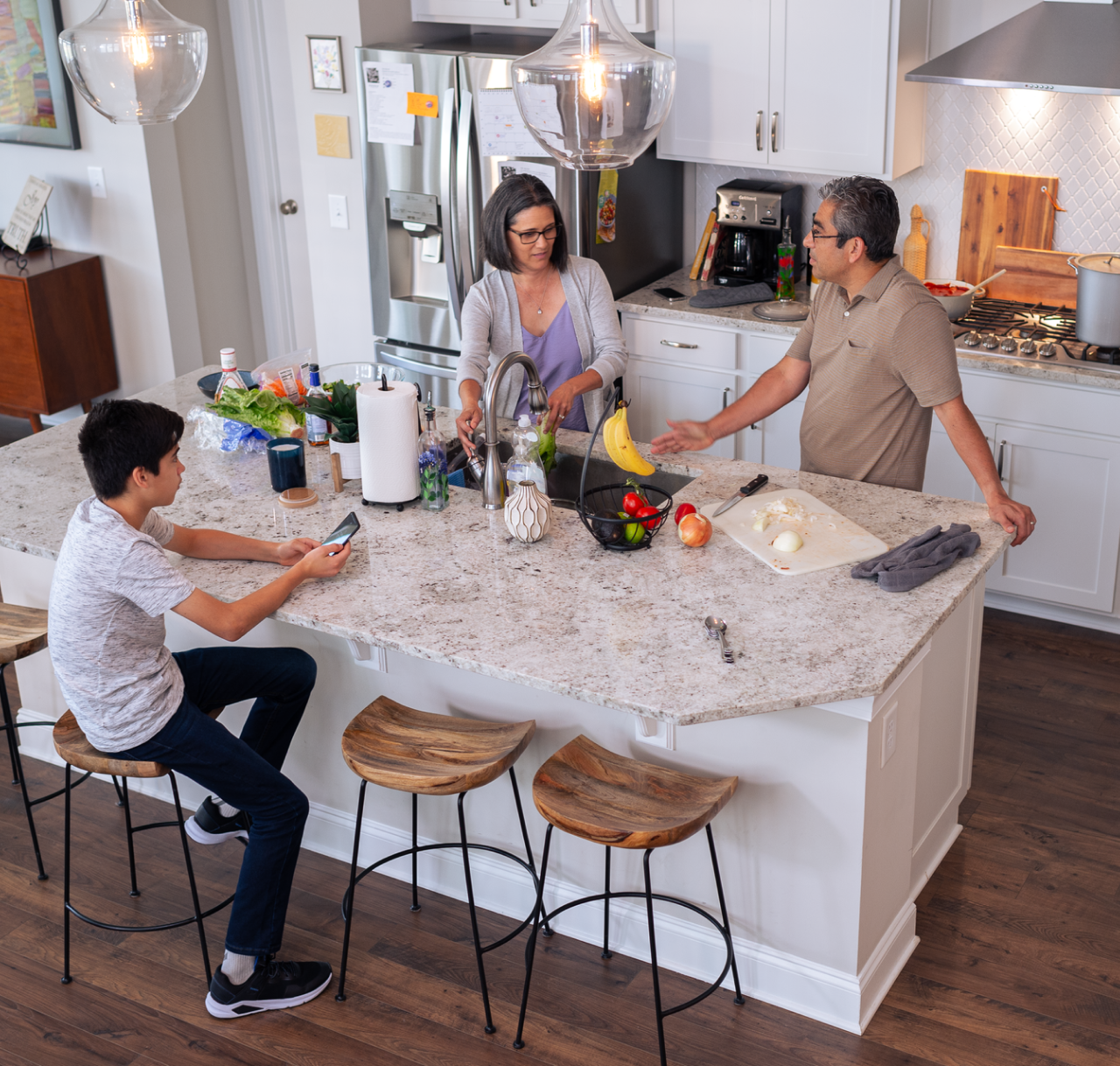 family talking in kitchen