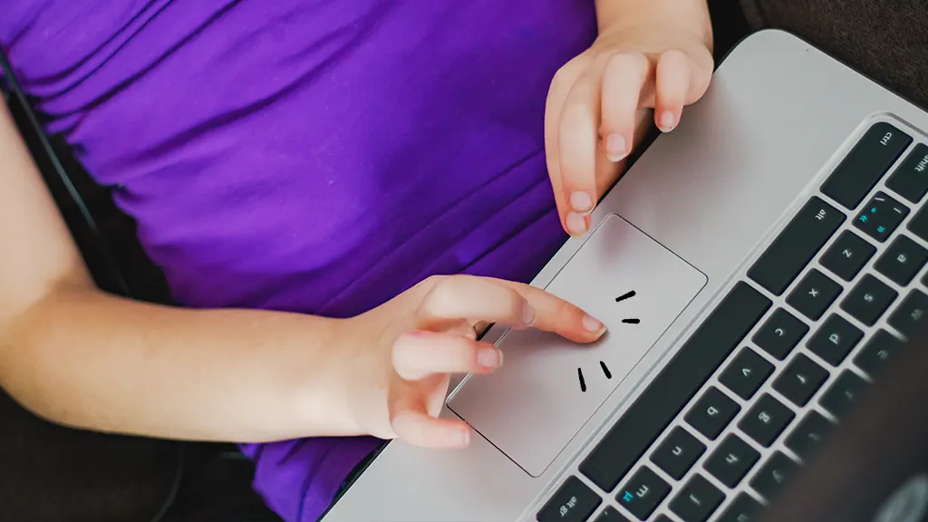 Hands touching a Chromebook touchpad that's not working