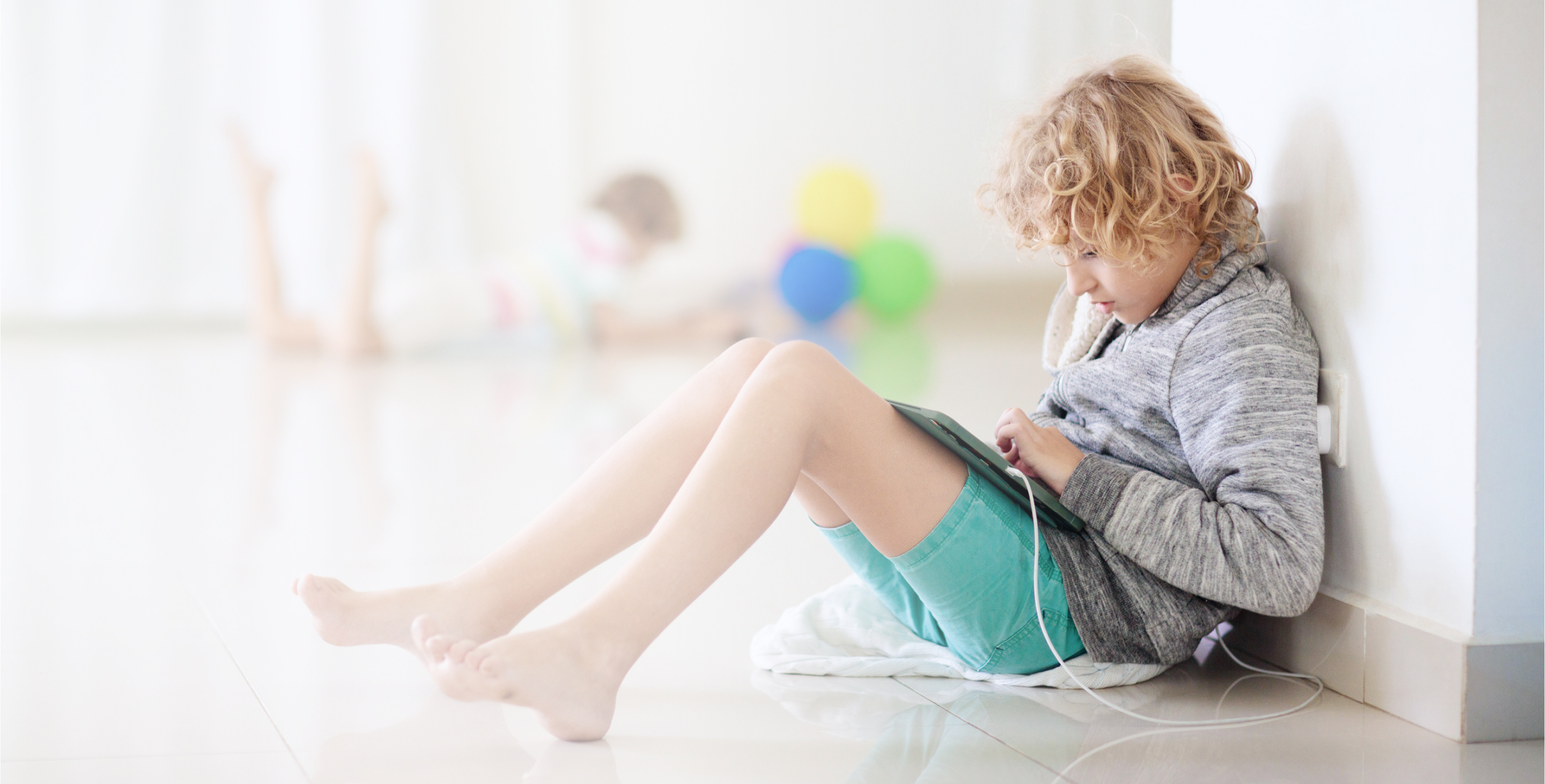 a child enjoying their tablet while it is charging