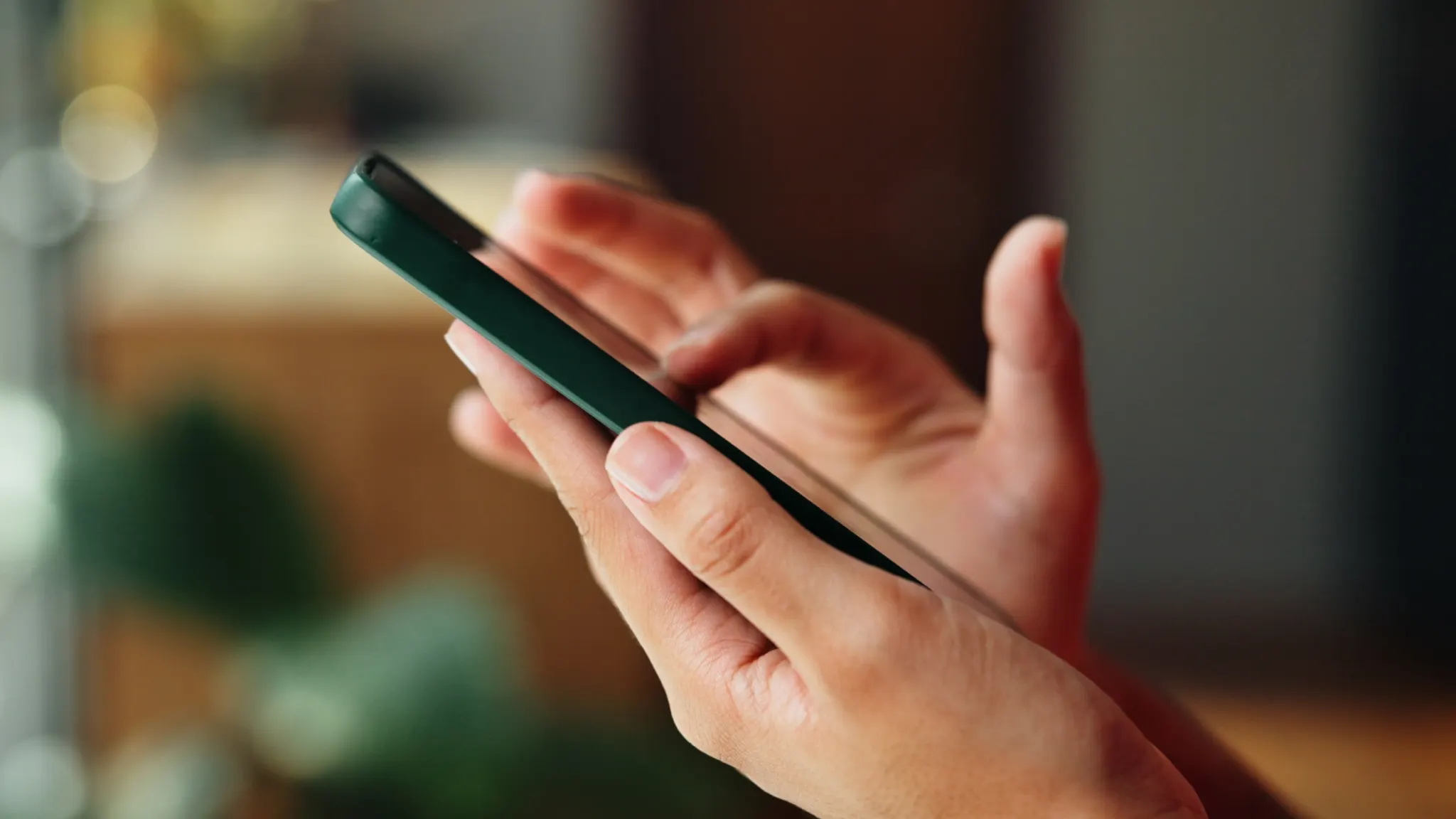 Person watching TikTok on phone, illustrating how to fix app issues on Android and iPhone devices