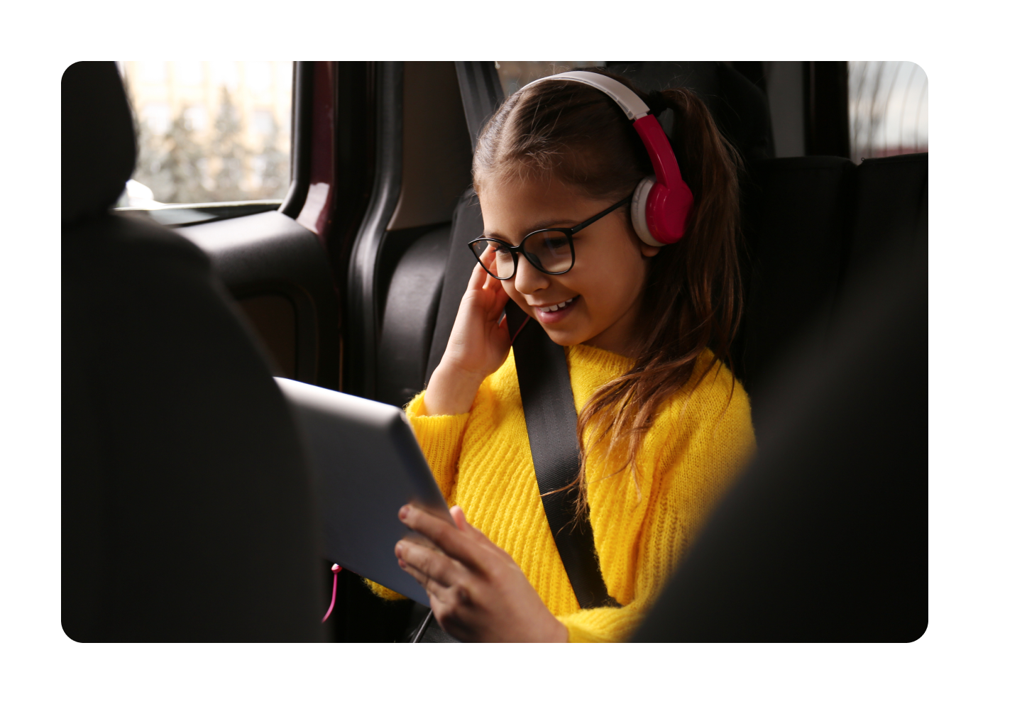 Kid in car seat with a tablet