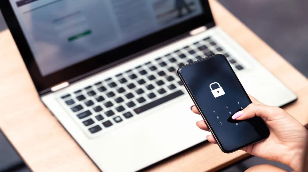 Person holding a phone that is displaying a lock screen with a numeric input pad