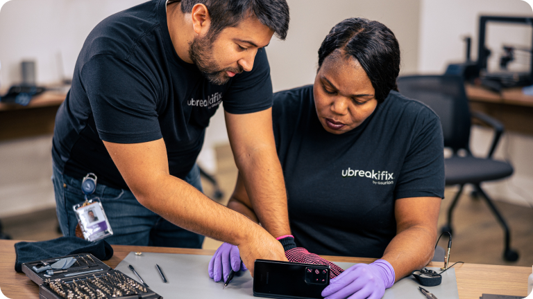 uBreakiFix technicians fixing a device