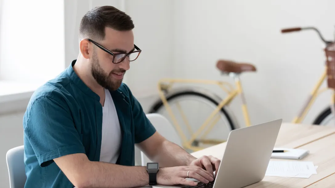 male typing on laptop