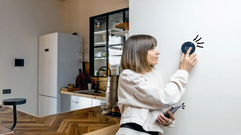 Woman looking at smart thermostat for issues