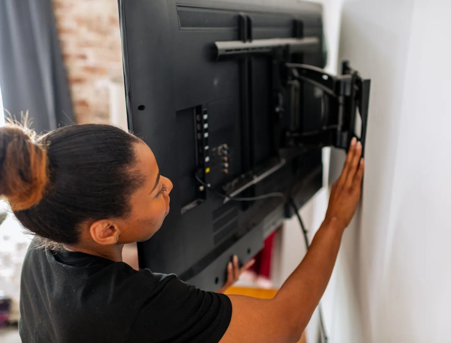 Woman installing a TV