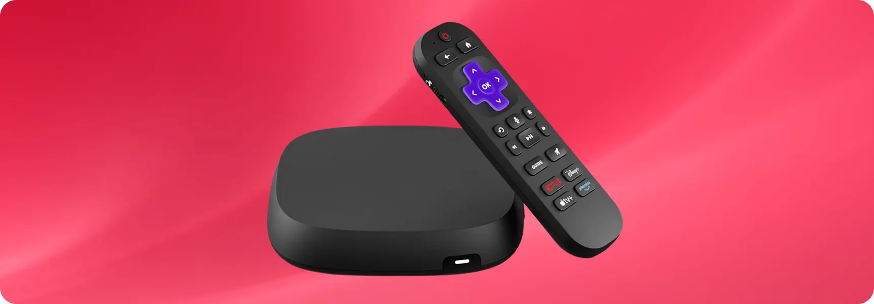 Streaming media player box with remote control on a red background.
