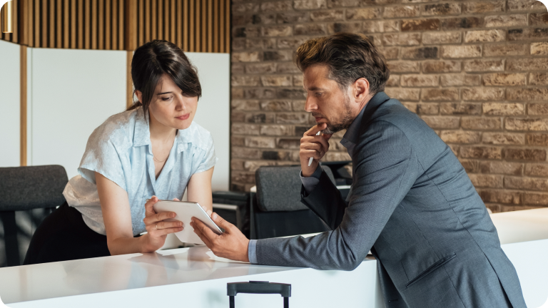 Man getting help from a desk in a hotel lobby