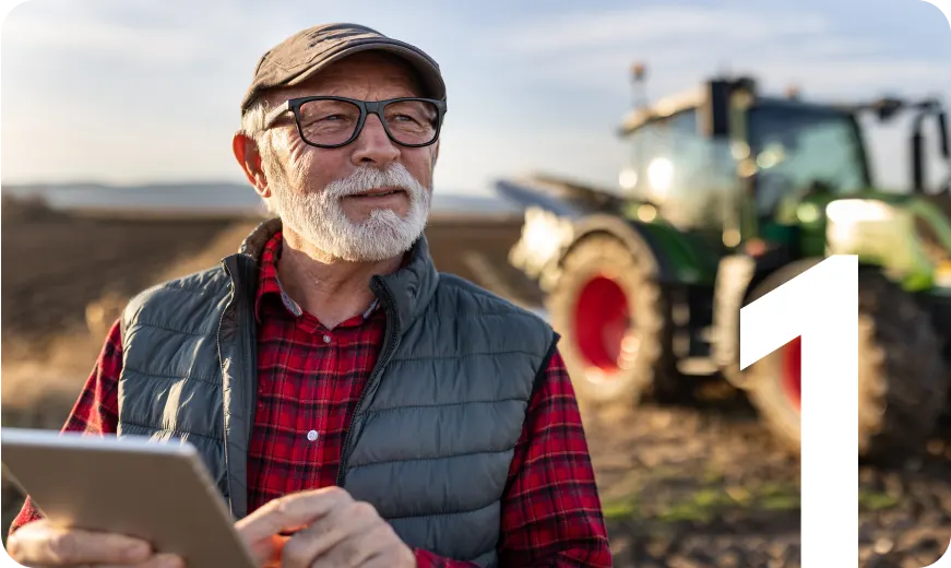 Older man on a farm with a tablet