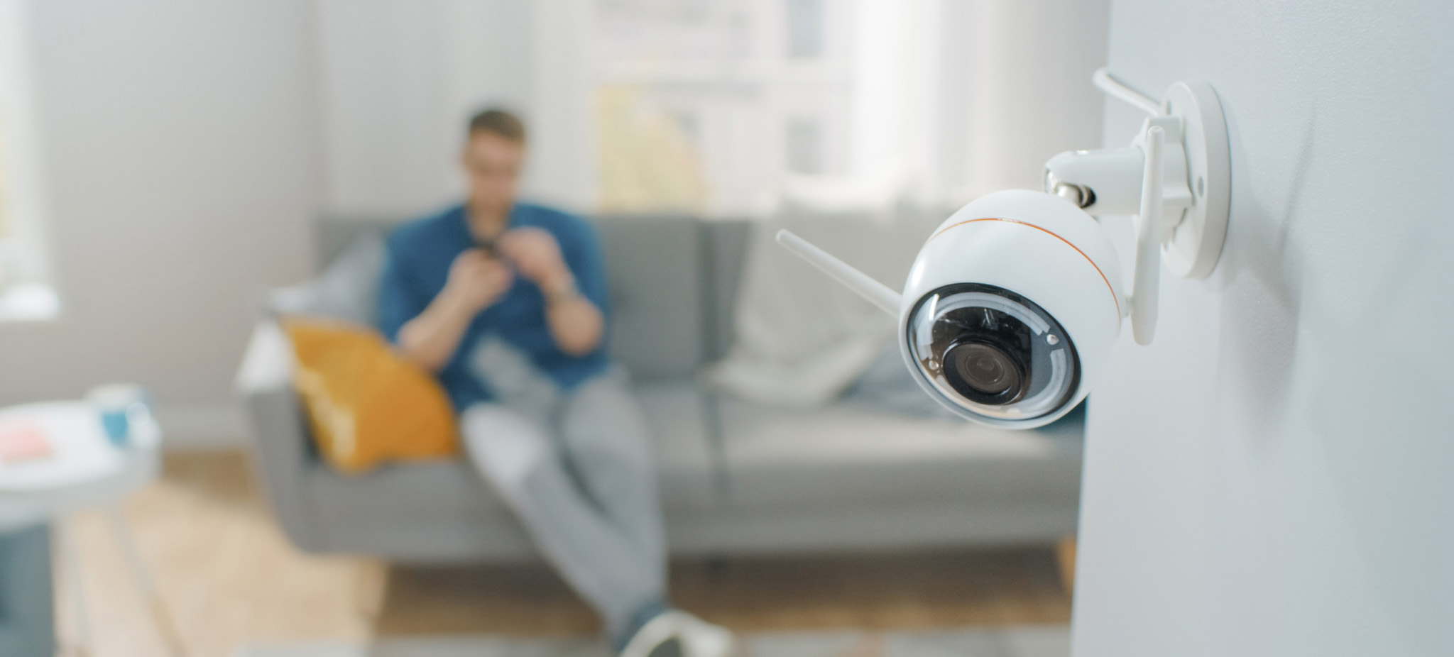 Indoor security camera mounted on wall in home