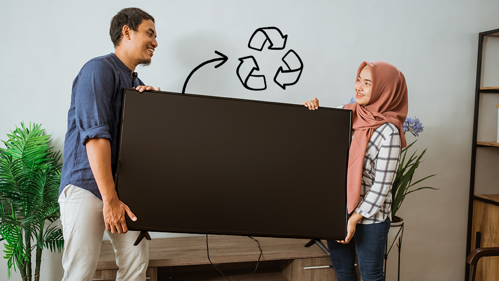 Man and woman carrying TV to recycling