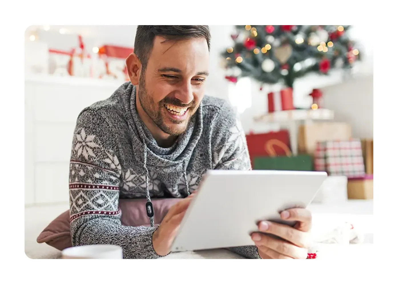 Sitting under a christmas tree with a tablet