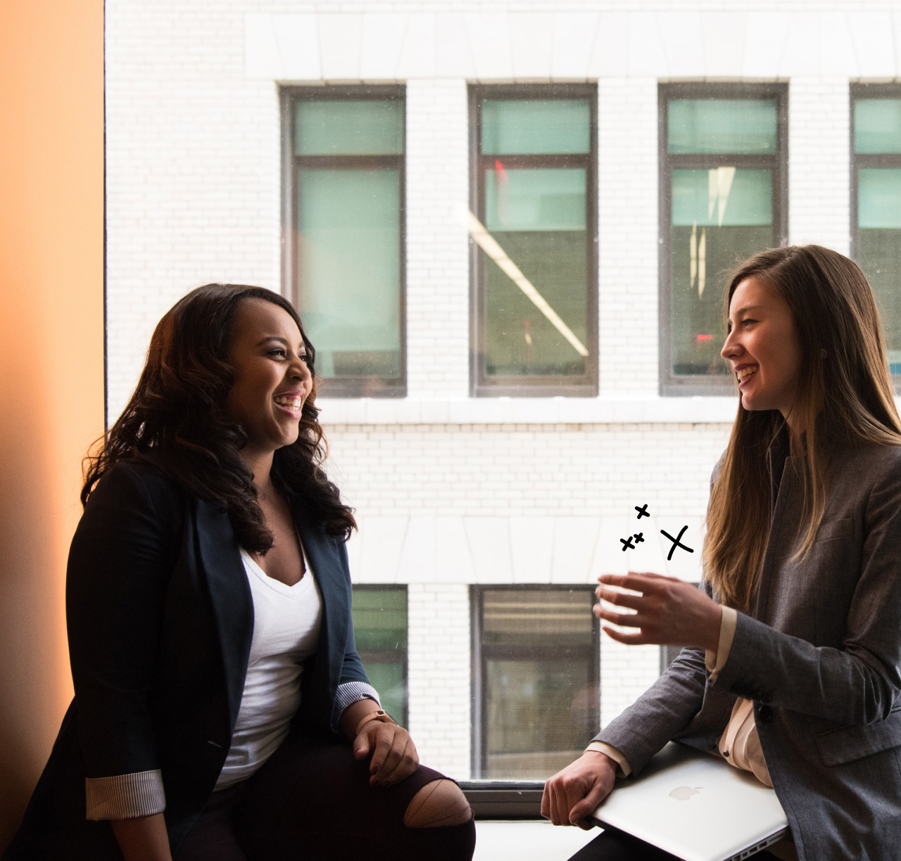 two women talking by office window