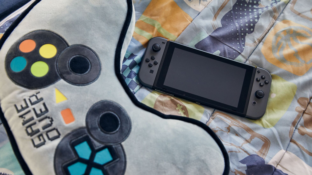Nintendo switch laying on game over blanket