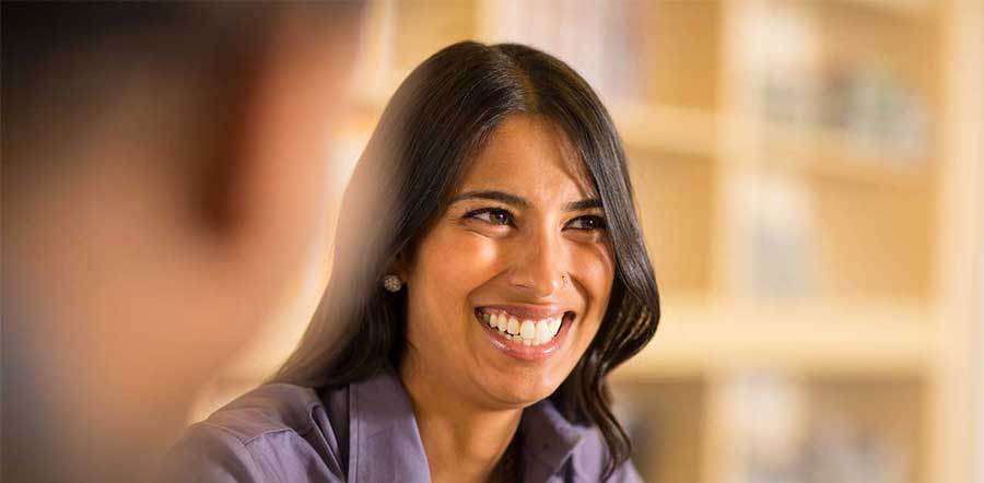 woman smiling looking off camera 