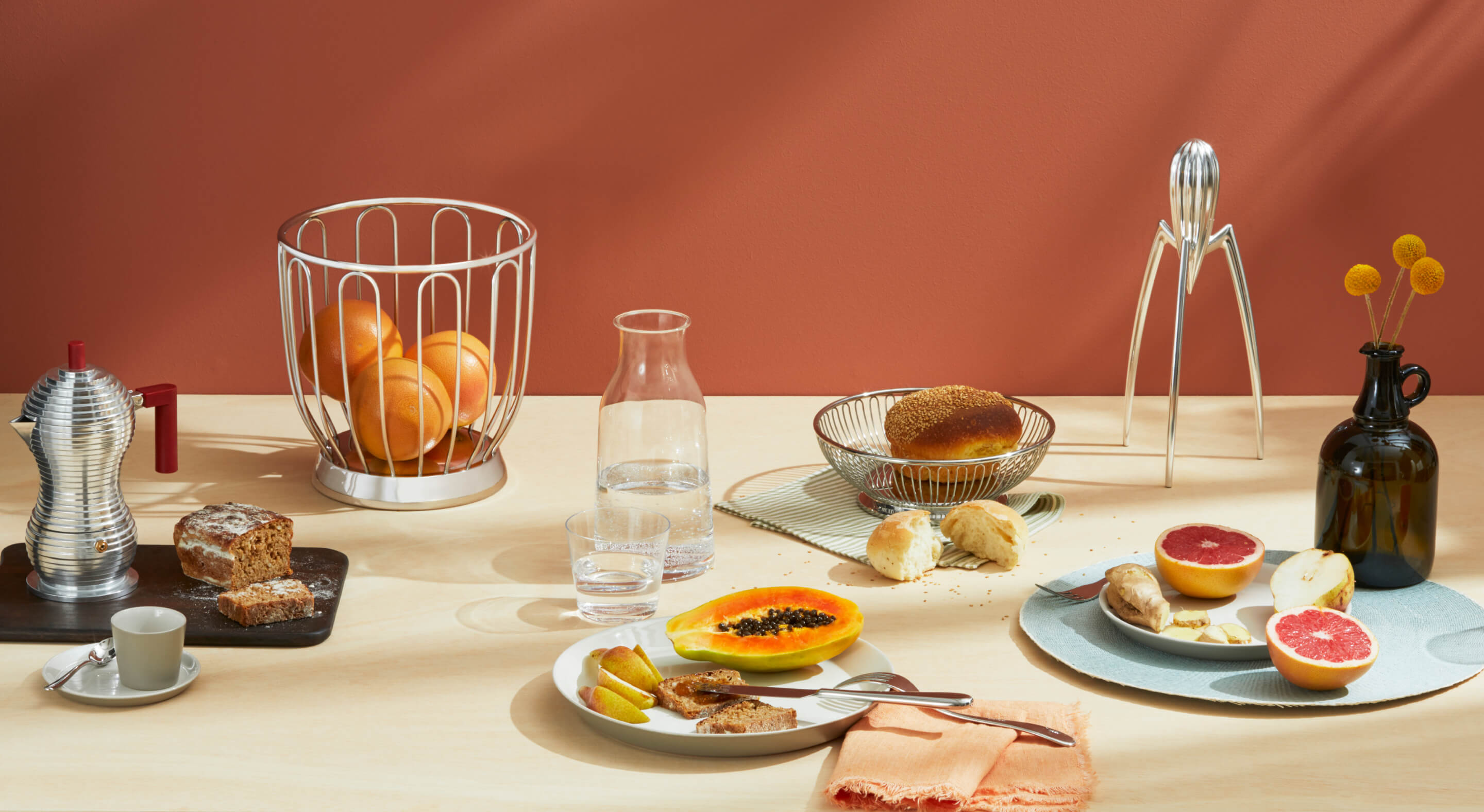 A table set with a breakfast spread served on modern plates.