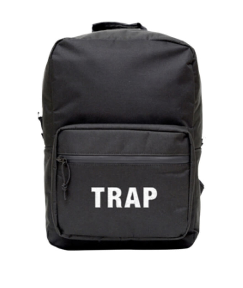 A black knapsack that reads “Trap” on the back pocket.